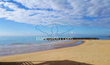 sandy beach and blue sea with christal water in marina di ragusa